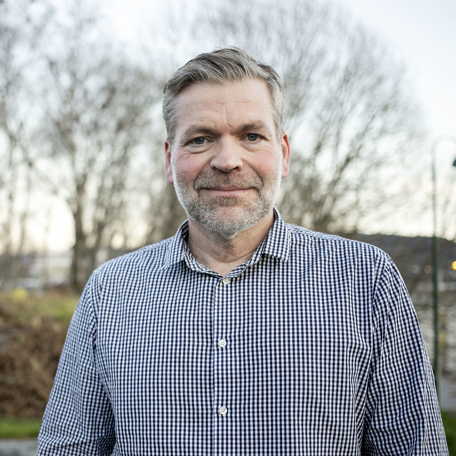 En mann som smiler til kameraet