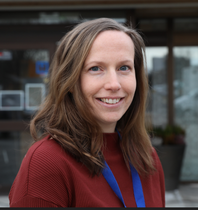 En kvinne som smiler til kameraet