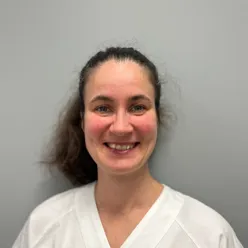 En kvinne som smiler til kameraet