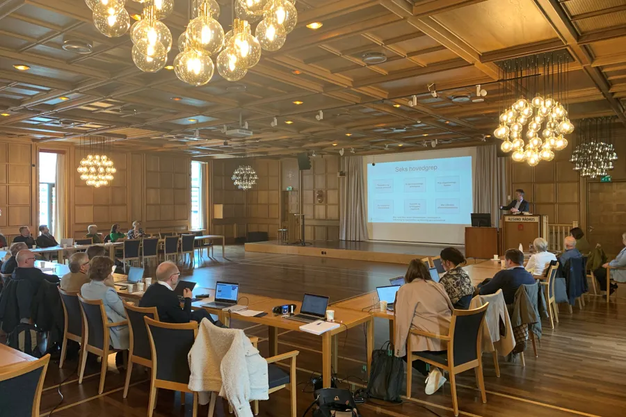 En gruppe mennesker som sitter ved bordene