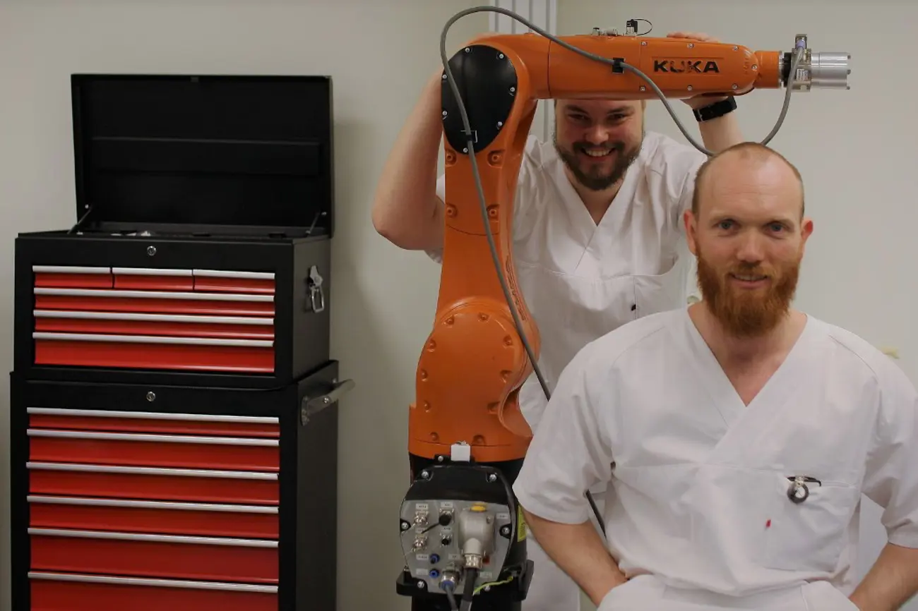 Bilde av industrirobot og to ortopeder.